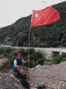 Tibetan grandma with Chinese flag.